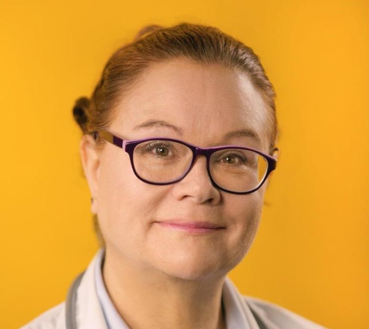 Dr. Josephine Ruiz-Healy smiling in a studio portrait